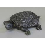 A stamp holder in the form of a tortoise