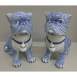 A pair of pottery pugs