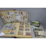 Two albums of cigarette and tea cards and a collection of postcards