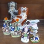 A collection of Staffordshire pottery; two Spaniels, two spill holders, one a/f, early 19th