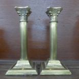 A pair of brass Corinthian column candlesticks