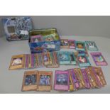A tin of Yu-Gi-Oh cards including first edition