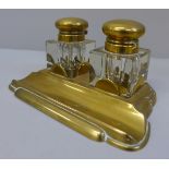 A brass inkstand with a pair of glass brass topped ink bottles