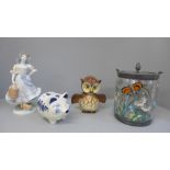 A Royal Worcester figure, Delft piggy bank, Goebel money box and decorative lidded jar