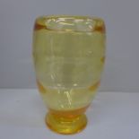 A Whitefriars golden amber vase with optic ribbing, designed by W. Wilson