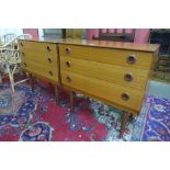 A pair of teak chests of drawers