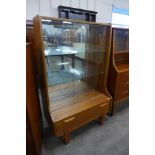 A teak display cabinet