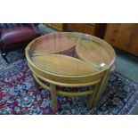 A Nathan Trinity teak and glass topped circular nest of tables