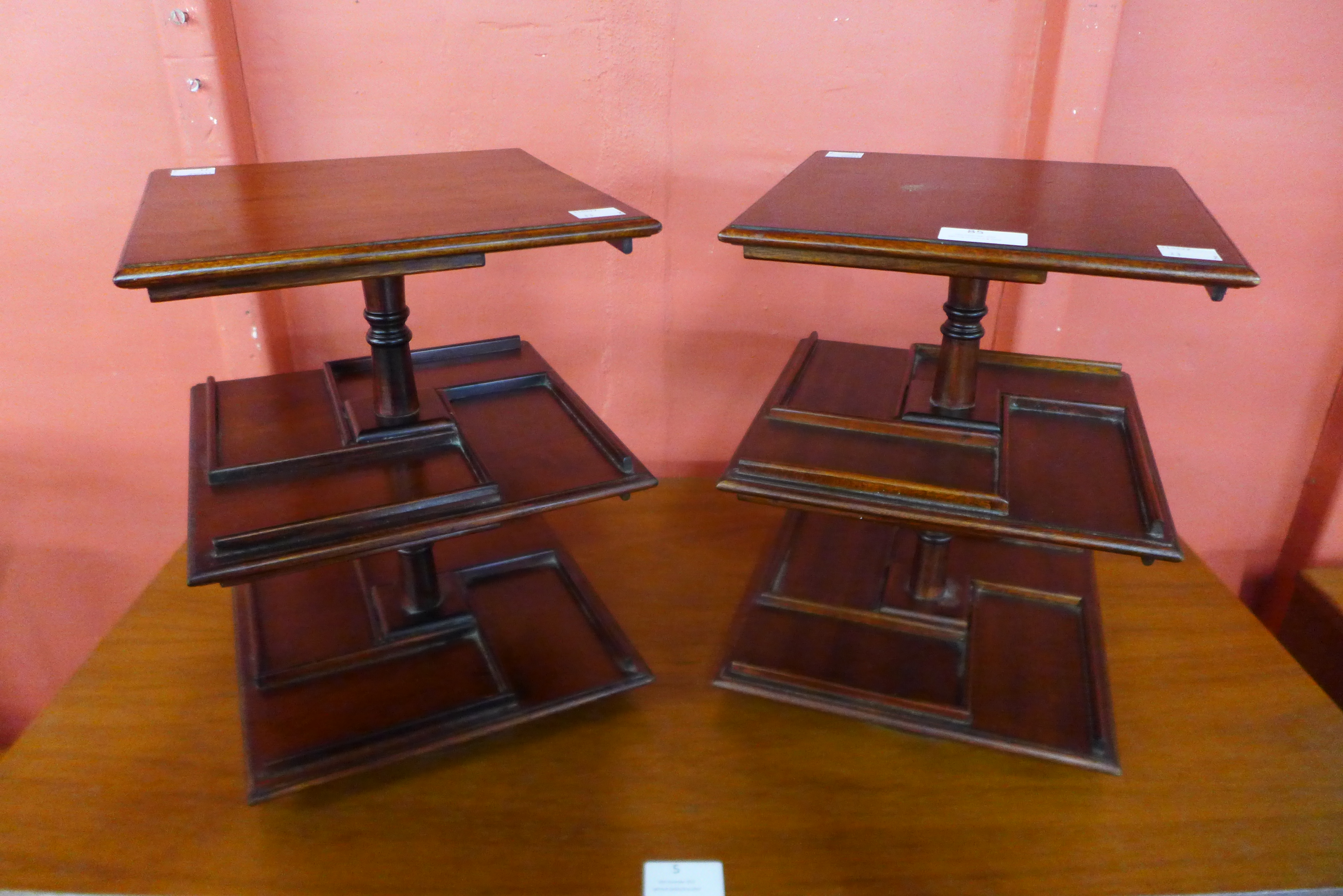 A pair of mahogany revolving desk stands, 30cms h