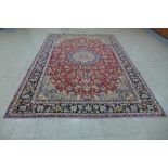 A Persian red ground Tabriz rug, 368 x 279cms