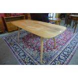 An Ercol elm and beech 382 model plank top dining table