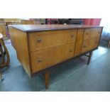 A Homeworthy teak four drawer sideboard