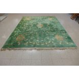 A large Chinese green ground rug