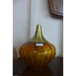 An amber glass onion shaped ceiling light