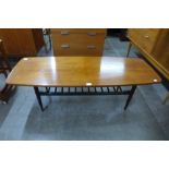 A teak and black painted coffee table
