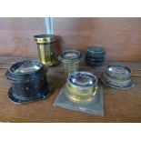 Six vintage camera or magic lantern lenses, one marked Perken, Son and Rayment, Hatton Garden, Rapid