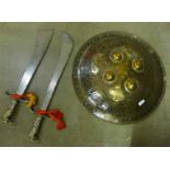 An Indian brass dhal and two swords