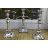 Two silver plated candlestick holders and a candelabra