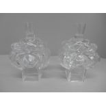 A pair of signed 1970s Swedish art glass signed candle holders in scroll and heart shaped form by