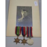 A photograph of a soldier and three WWII medals including the Pacific Star