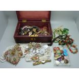 Costume jewellery and gemstone pendants in a vintage jewellery box