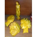 Art Deco style ornamental items, three face masks and a nude figure