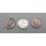 Three uncirculated threepence coins