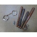 Four truncheons, handcuffs and a whistle