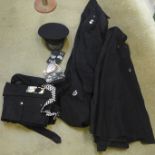 A collection of Police uniforms; cape, peaked cap, badge and shoulder pips, etc.