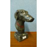 A small concrete bust of a greyhound