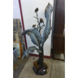 A large bronze abstract sculpture of birds on a tree