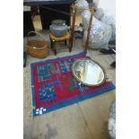 An Islamic brass jardiniere, a gilt framed mirror, a small rug, basket, etc.