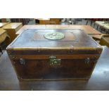 A brown leather trunk, the top inset with Milners' Patent Fire Resistant brass plaque