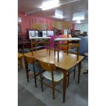 A teak extending dining table and six chairs