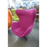 An Arne Jacobsen style chrome and pink fabric revolving egg chair
