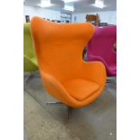 An Arne Jacobsen style chrome and orange fabric revolving egg chair