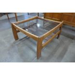 A teak and glass topped square coffee table