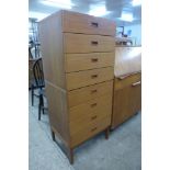 A tall teak chest of drawers