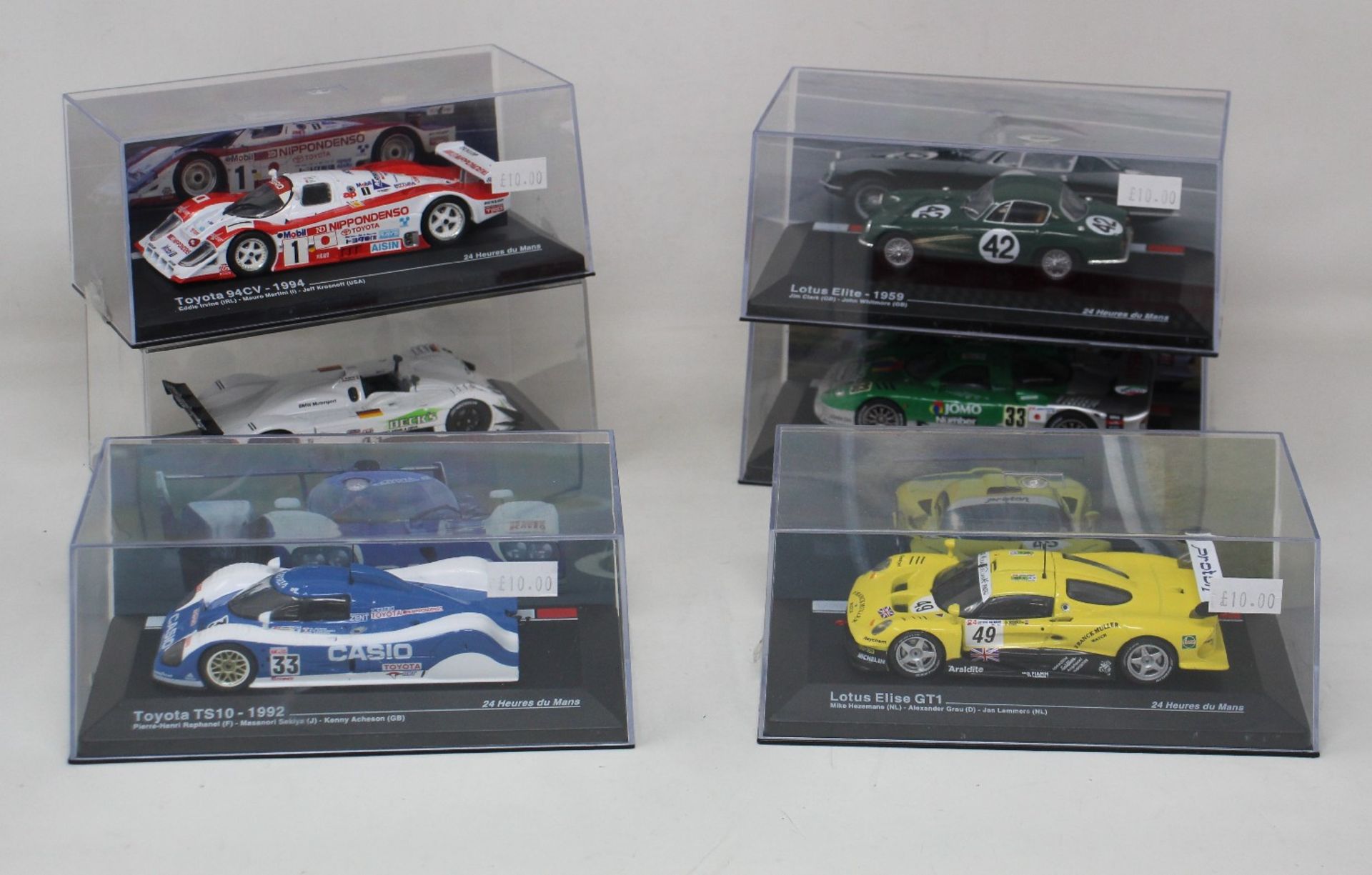 A collection of thirteen 1:43 scale motor racing model cars from multiple manufacturers. To include