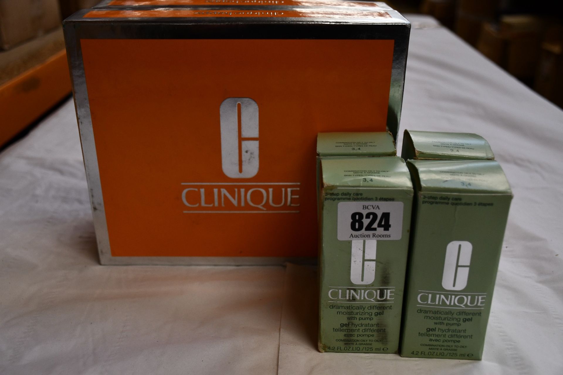 Two Clinique Happy trio gift set eau de parfum and hand cream and four Clinique moisturising gel