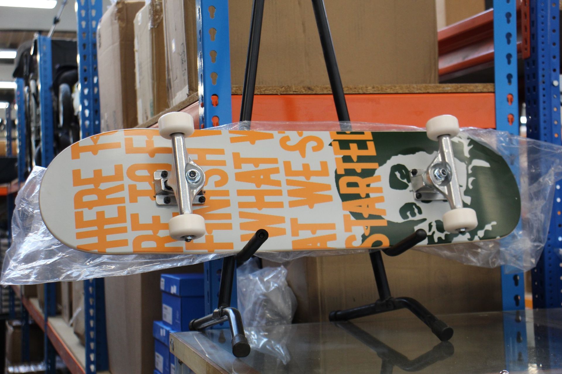 An as new Banksy x Clown Manifesto Orange Skateboard.