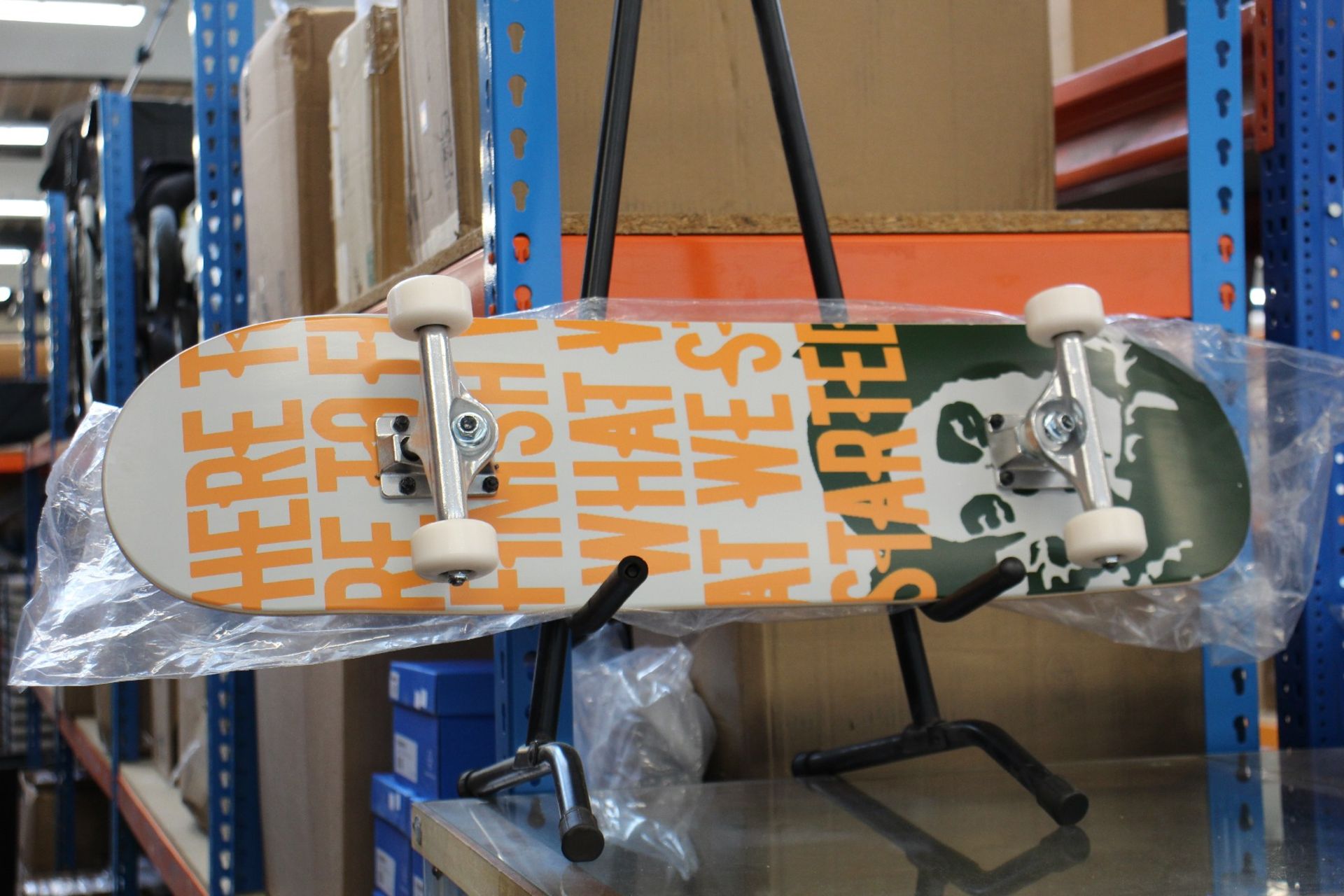 An as new Banksy x Clown Manifesto Orange Skateboard.