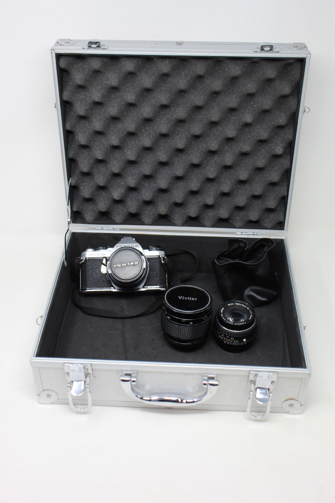A pre-owned Pantex ME Super 35mm camera with two Pantex lenses and a Vivitar lens with a hard case.