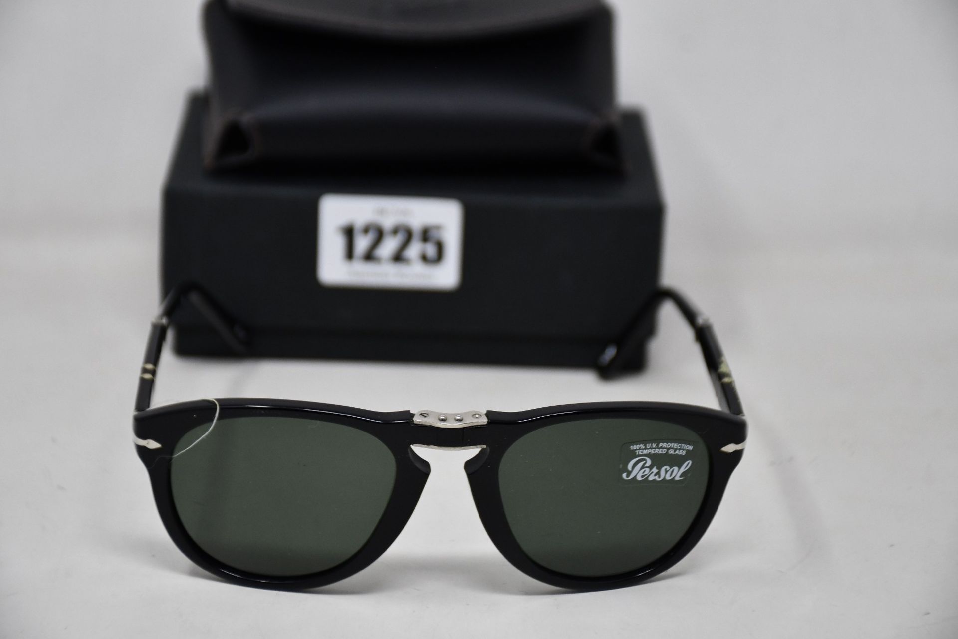 A pair of as new Persol PO0714 folding sunglasses.