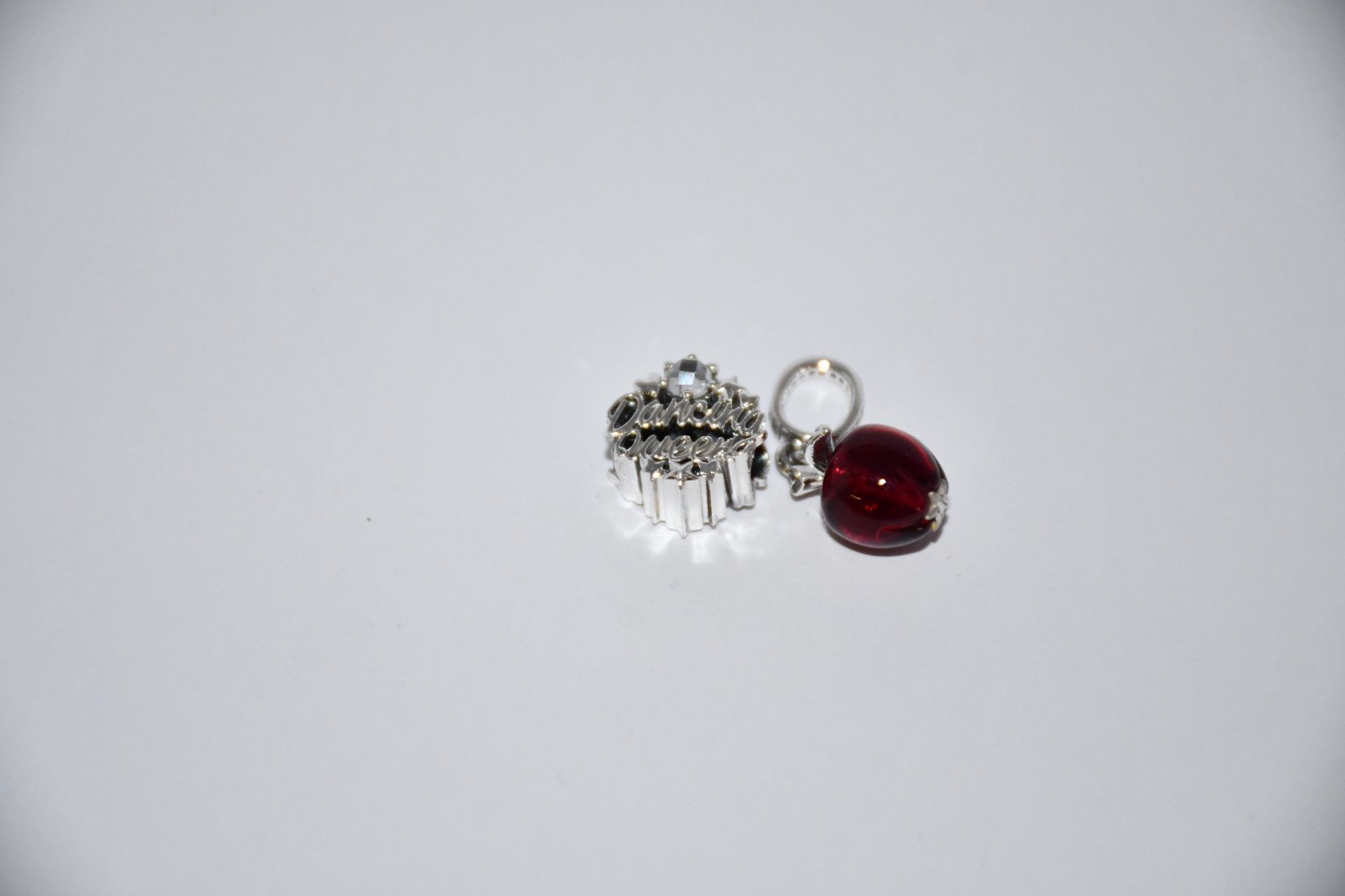 Two Pandora Murano Glass Red Apple Dangle charms (RRP £40) and two Pandora Dancing Queen charms (RRP