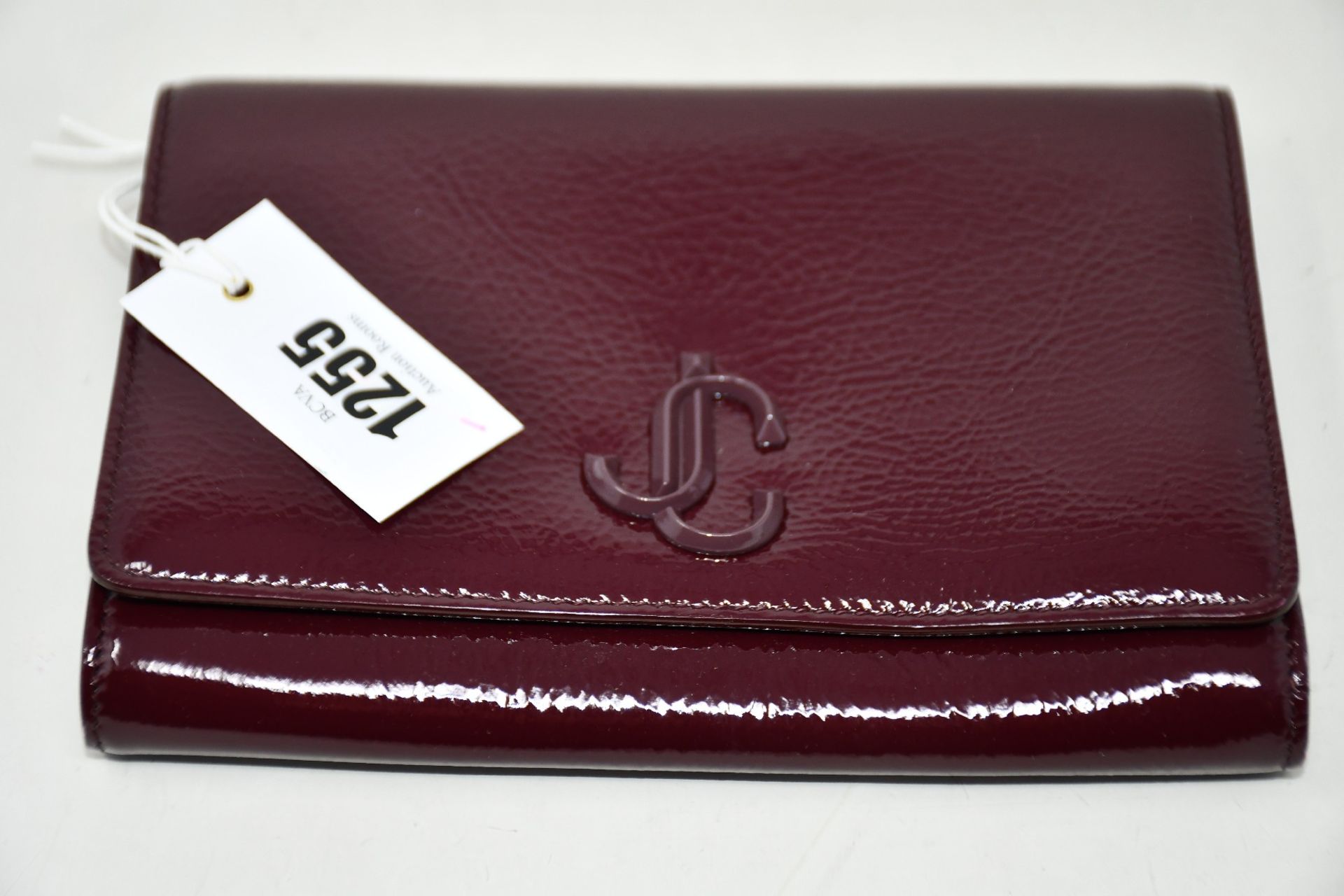An as new Jimmy Choo Varenne clutch in merlot (No tags but item is as new - RRP £695).