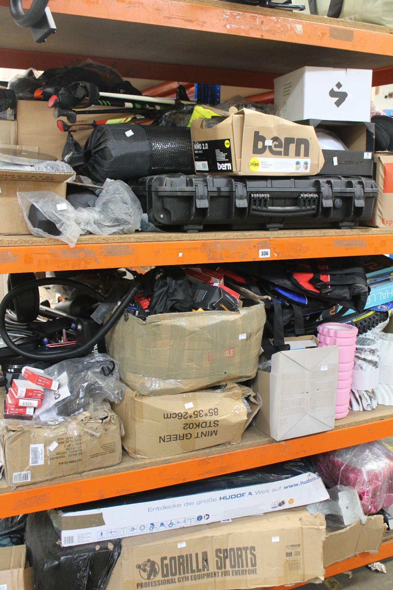A large quantity of sports equipment and related items.