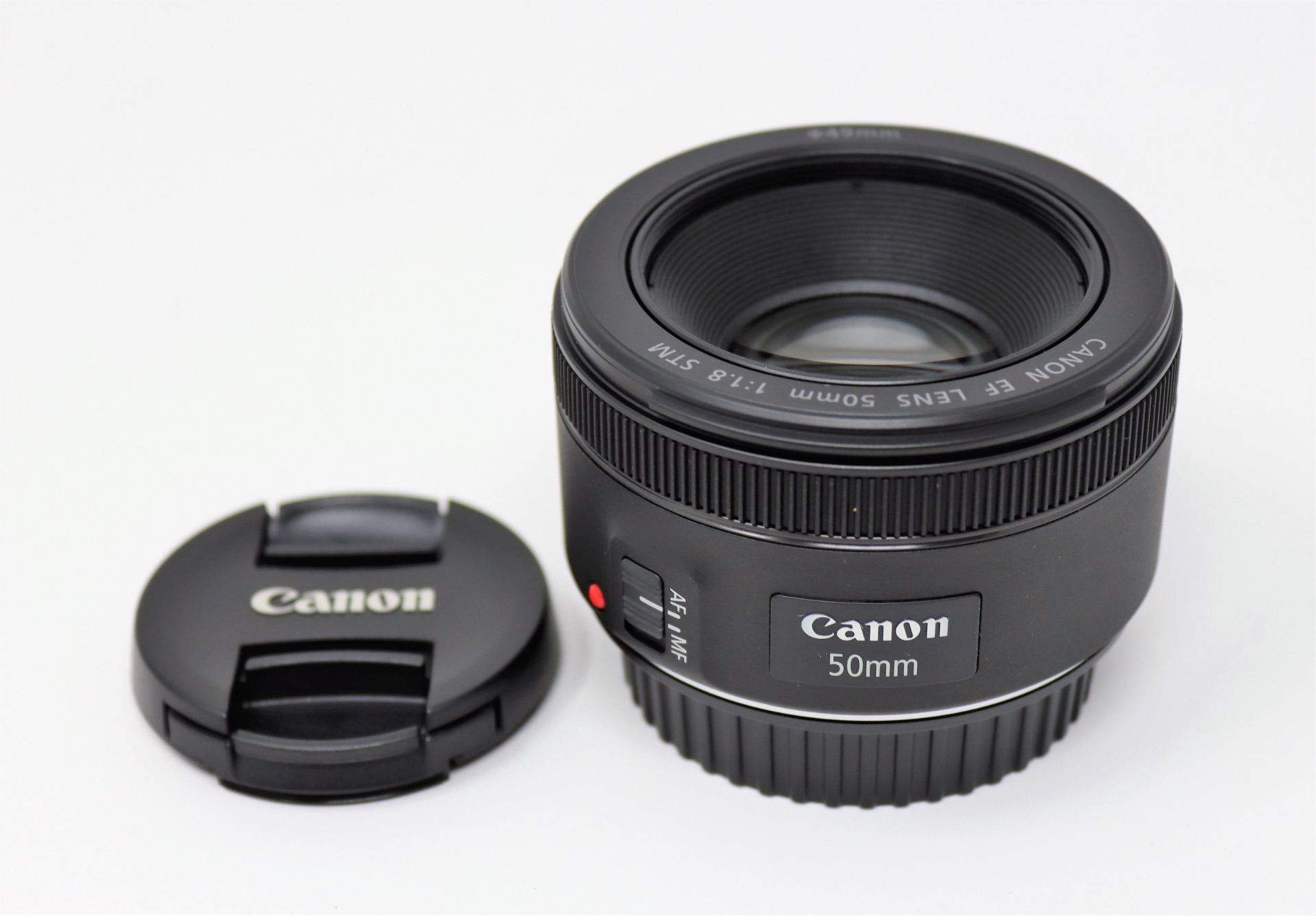 A boxed as new Canon EF 50mm f/1.8 STM lens.