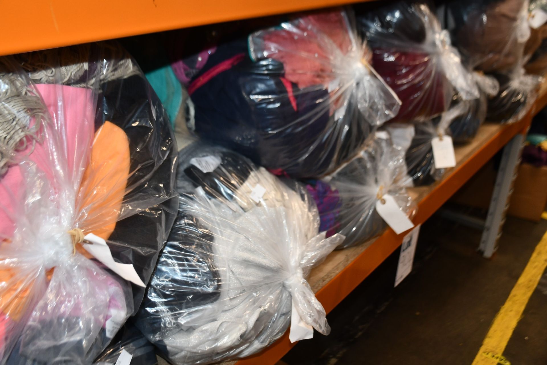 Eleven bags of pre-owned clothing and related items.