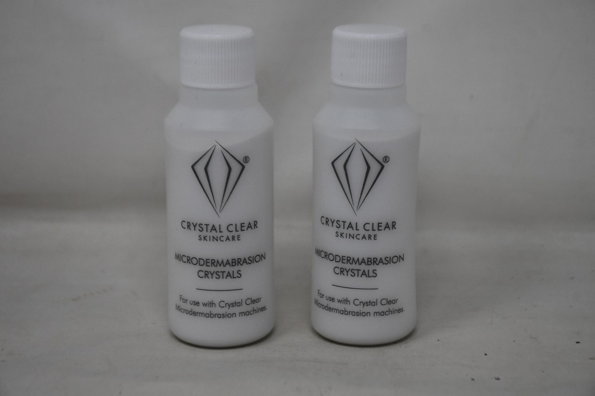 A box of as new Crystal Clear Skincare microdermabrasion crystals (52 bottles per box, 85g